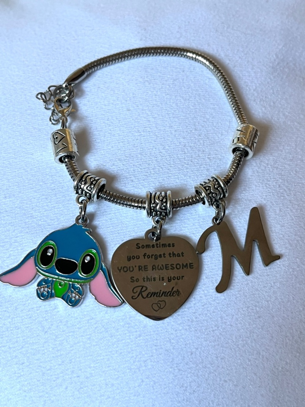 Silver Charm Bracelet with Blue Stitch Pendant and Heart Reminder Charm